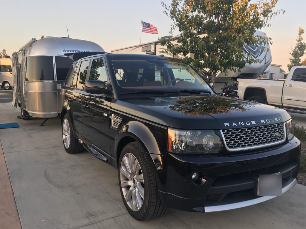 Range Rover Sport with an Airstream trailer at golden hour